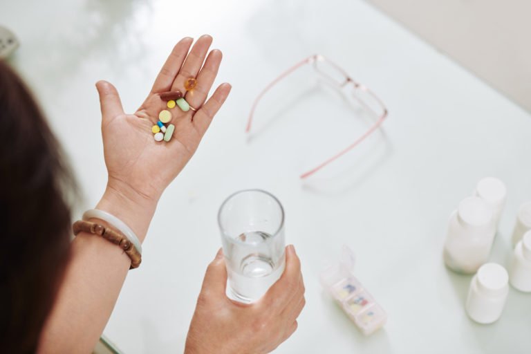 woman-taking-pills-and-supplements